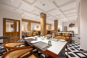 a dining room with wooden tables and chairs at Hotel Mountain Mirage in KumhÄrsain