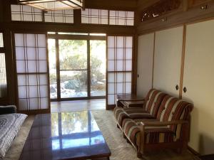 a living room with a couch and a coffee table at 森のしずく in Azumino