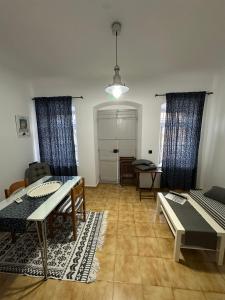 a living room with a table and a couch at Evangelia in Symi