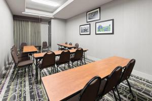 a conference room with wooden tables and chairs at La Quinta by Wyndham Kyle - Austin South in Kyle
