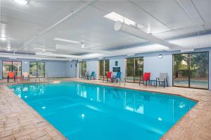 a large swimming pool with blue water in a building at La Quinta by Wyndham Clarksville in Clarksville