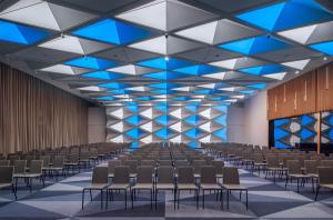 an empty room with rows of chairs and a stage at Andaz Munich Schwabinger Tor, By Hyatt in Munich +106 photos