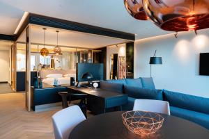 a living room with a couch and a table at Andaz Munich Schwabinger Tor, By Hyatt in Munich