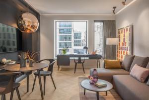 a living room with a couch and a table at Andaz Munich Schwabinger Tor, By Hyatt in Munich