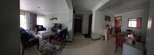 a living room with a couch and a table and a living room with a unintention at Cafe La Vida in Mbarara +20 photos