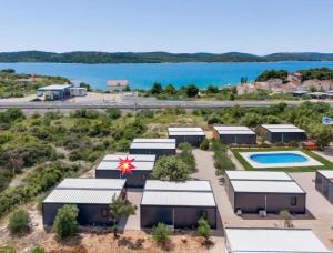 an aerial view of a group of buildings with a lake at Mobilhome Maja in Pirovac