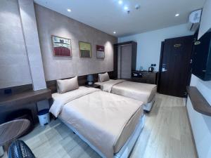 a hotel room with two beds in a room at Moon Inn Apartment-self check in in Hanoi