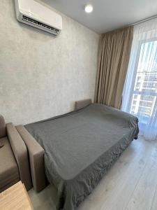 a bedroom with a bed and a air conditioner on the wall at ЖК Парус, 10-1 in Chornomorsk