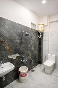 a bathroom with a toilet and a sink at Hotel Tirupati Heights Ujjain # Near Railway Station # Top Rated Property in Ujjain