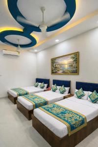 three beds in a room with a ceiling at Hotel Tirupati Heights Ujjain # Near Railway Station # Top Rated Property in Ujjain +5 photos