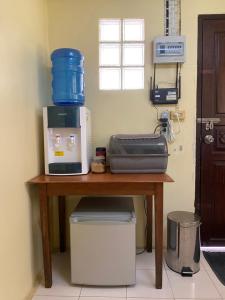 a table with a coffee maker on top of it at Roy Lao House in Khao Lak