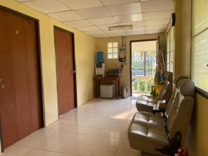 a waiting room with a row of chairs in a hospital at Roy Lao House in Khao Lak
