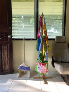 a room with a broom and an umbrella and a chair at Roy Lao House in Khao Lak +35 photos