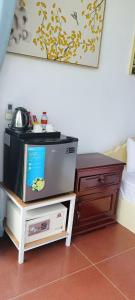 a tv sitting on a stand next to a bed at ThmorDa Resort in Koh Rong Sanloem +49 photos