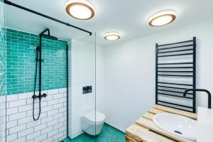a bathroom with a glass shower and a sink at Káli Kert Vendégház in Szentbékkálla +44 photos