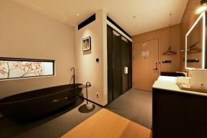 a bathroom with a black tub and a sink at a1 Art Hotel in Quanzhou +81 photos
