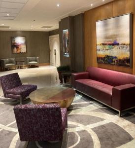 a lobby with a couch and a table and chairs at DoubleTree by Hilton Akron Fairlawn in Fairlawn