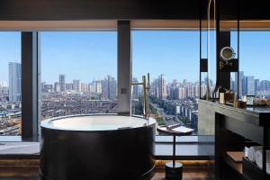 a bath tub in a room with a large window at SEYA Design Hotel - Chengdu Taikoo Li - Managed by SEYA GROUP in Chengdu +45 photos
