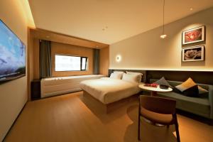 a hotel room with a bed and a couch at a1 Art Hotel in Quanzhou