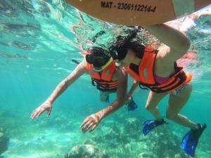 two people in the water in the ocean at Lodge Arenas Costa Maya in Mahahual