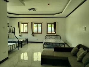 a living room with two beds and a couch at Safe Haven Residence in Talibon +12 photos