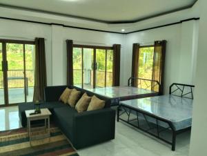a living room with a couch and a glass table at Safe Haven Residence in Talibon