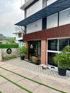 a building with a cat sitting outside of it at JK Residency in Kunnamangalam