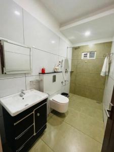 a bathroom with a sink and a toilet and a shower at JK Residency in Kunnamangalam