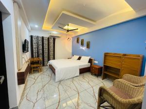 a bedroom with a bed and a dresser in a room at JK Residency in Kunnamangalam