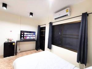 a bedroom with a white bed and a chalkboard at The One Hotel in Pattaya