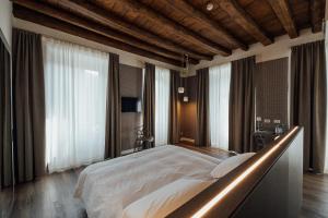 a large bedroom with a large bed with a lightedppelin at Hotel Bigio in San Pellegrino Terme