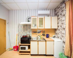 a small kitchen with white cabinets and a sink at Basic Apartment for up to 5 guests in Burgas