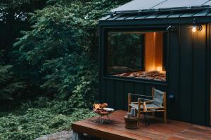 a black tiny house with a bed in the window at awake Gojome in Akita +9 photos