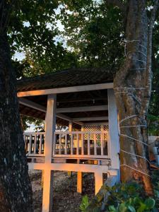 a white and orange porch with a tree at Damar Tree Resort in Krui +2 photos