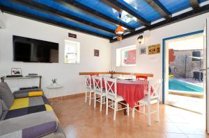 a living room with a table and a couch at Islander house with pool in Trogir