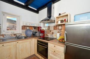 a kitchen with wooden cabinets and a stainless steel refrigerator at Islander house with pool in Trogir