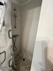 a bathroom with a shower with a black and white at Charming studio in a residence in Provence in Graveson