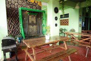 a room with two wooden benches and a stove at Mountain and Sunsetview Baguio Residences in Baguio