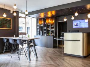 a restaurant with two tables and a bar at ibis Styles Paris 15 Lecourbe in Paris
