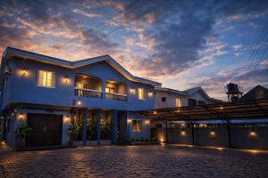 a white house with a sunset in the background at Luxury 6 bedroom villa in independence layout 247 power parking and Wifi in Enugu
