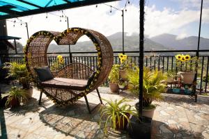 a heart shaped swing on a patio with flowers at Mountain and Sunsetview Baguio Residences in Baguio