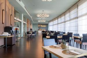 a restaurant with tables and chairs and a dining room at DoubleTree by Hilton Florence Metropole in Florence