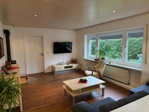 a living room with a couch and a table at Idyllische Wohnung in ruhiger Lage Nähe BAB A6! in Illschwang