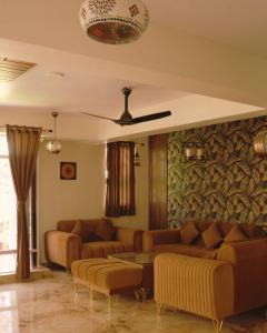 a living room with couches and a table at Pine Tree Resort Betla in Kechki