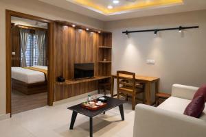 a living room with a couch and a table at Nova Regency in Bangalore