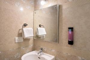 a bathroom with a sink and a mirror at Nova Regency in Bangalore