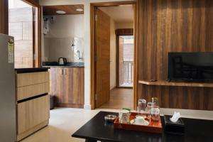a kitchen with a table and a tv in it at Nova Regency in Bangalore
