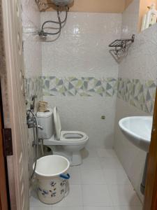a bathroom with a toilet and a sink at Satya Residency in Kākināda