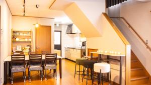 a kitchen and dining room with a table and chairs at mintstay kochi in Kochi
