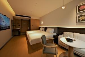 a hotel room with a bed and a table at a1 Art Hotel in Quanzhou